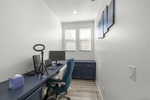 a bedroom with bed and window with chair