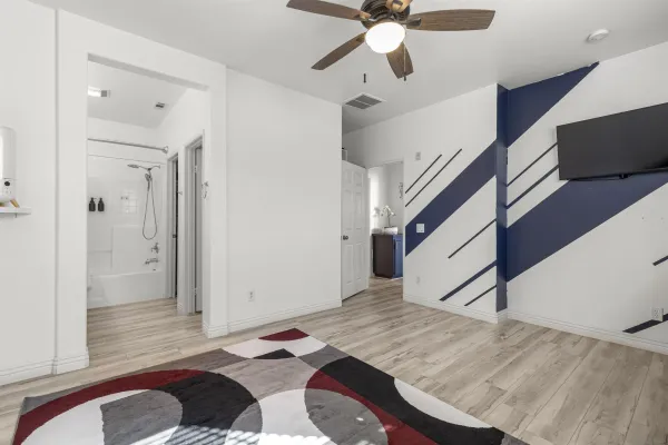 a bathroom with a double vanity sink a mirror a bathtub and shower