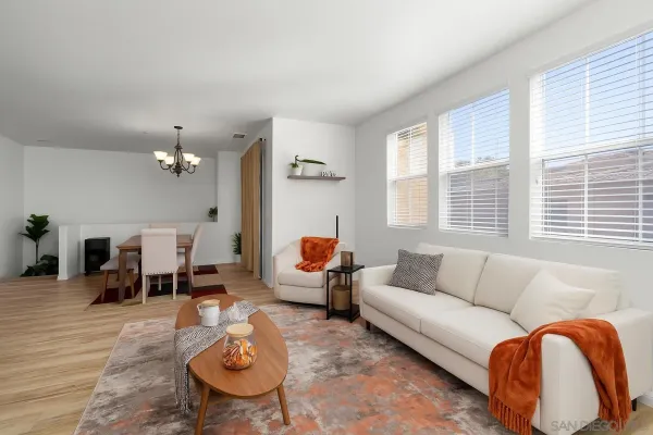 a living room with furniture and a chandelier