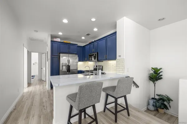 a kitchen with wooden cabinets and stainless steel appliances