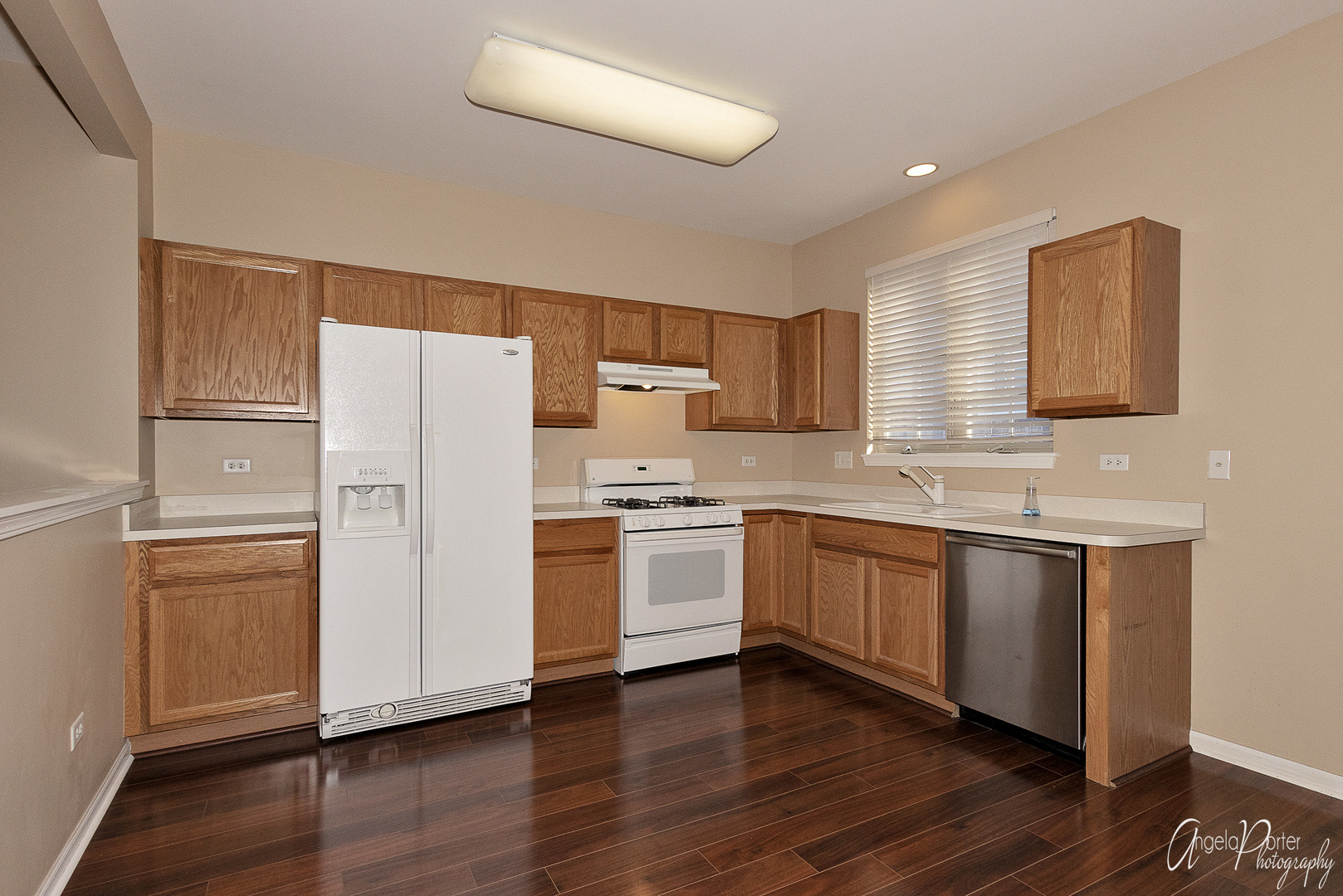 707 Prestwick Lane Wheeling, IL 60090 - Photo 4 of 29 a kitchen with a refrigerator cabinets and wooden floor