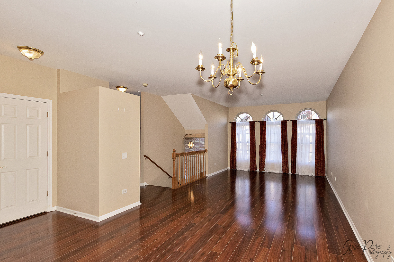 707 Prestwick Lane Wheeling, IL 60090 - Photo 8 of 29 a view of a room with wooden floor and chandelier