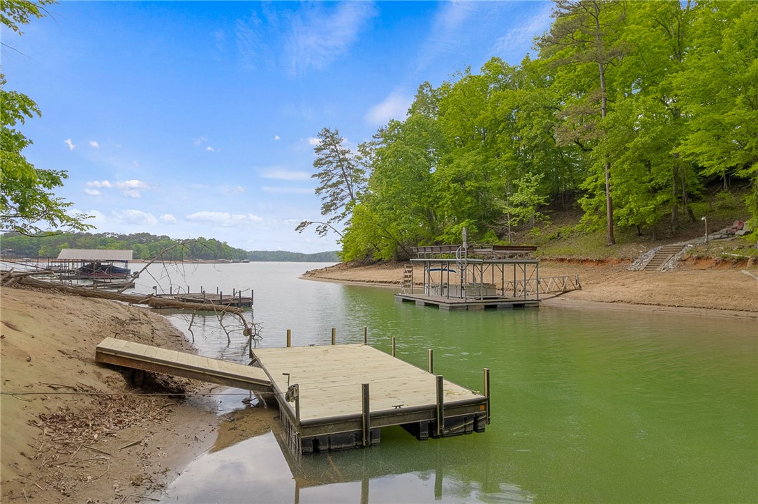 5 Shelor Ferry Road Fair Play, SC 29643 - Photo 2 of 17 Dock & Shoreline – A peaceful cove setting with a floating dock, sandy shoreline, and calm water access for lake enjoyment.