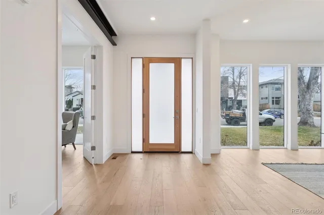 a view of a room with furniture and wooden floor