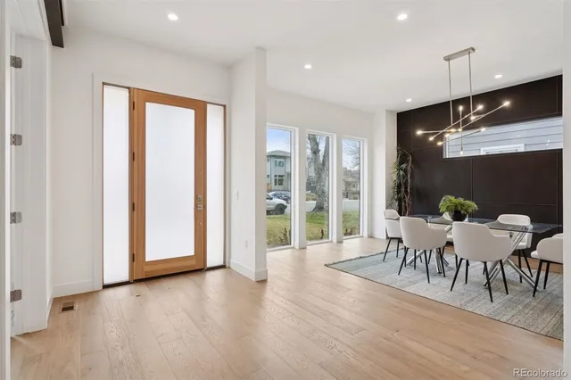 a dining room with furniture and wooden floor