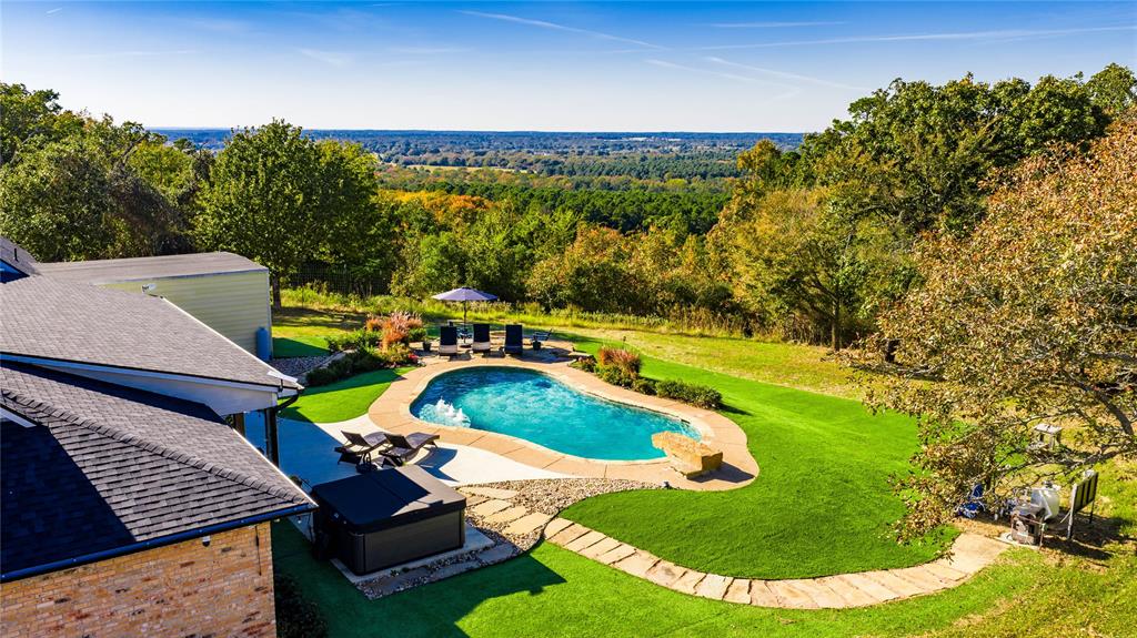 a view of a swimming pool with a yard
