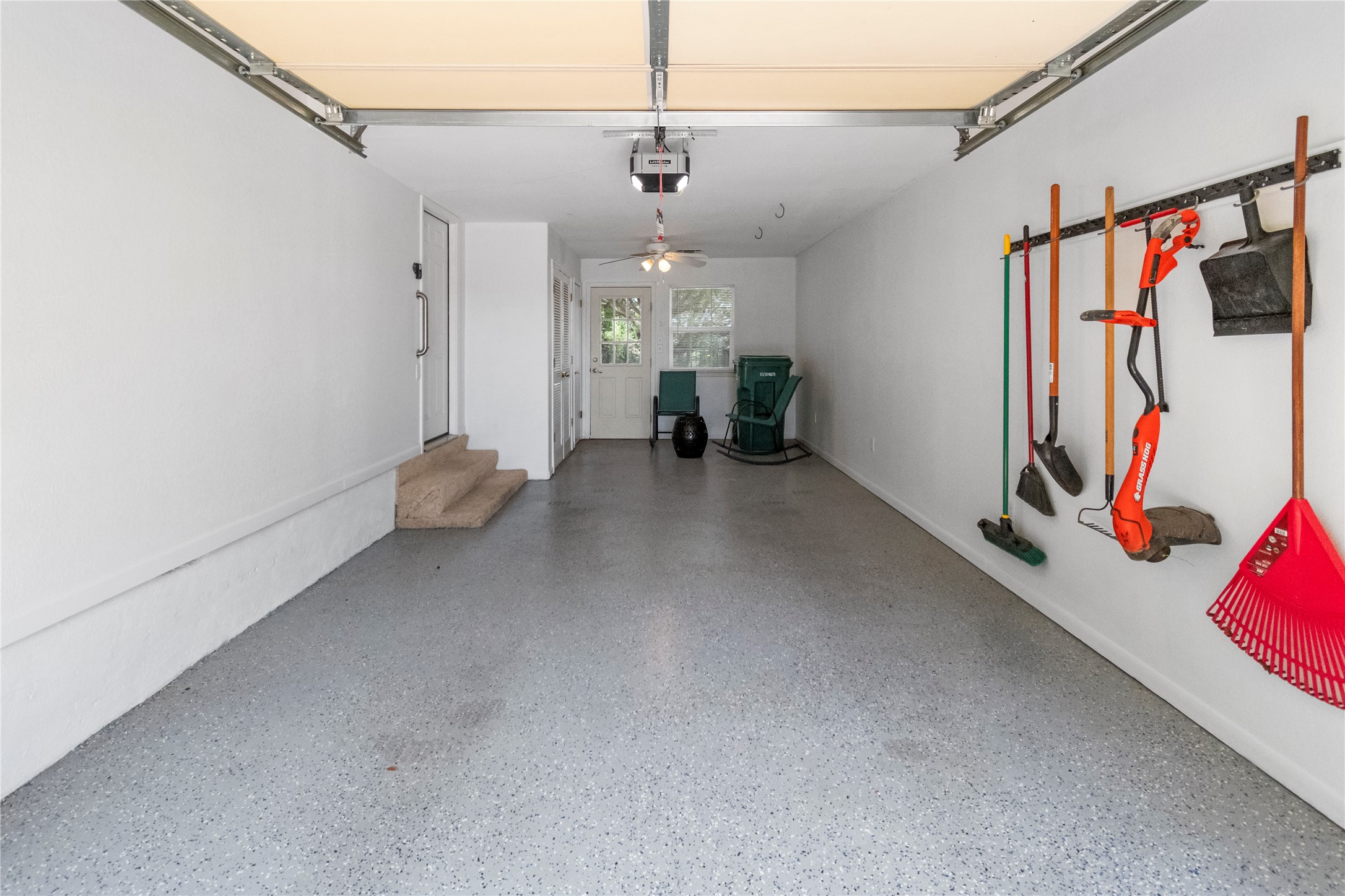 210 Teeoff, Unit B Horseshoe Bay, TX 78657 - Photo 33 of 38 A spacious garage with a durable epoxy floor and convenient side entry, offering ample storage and utility.