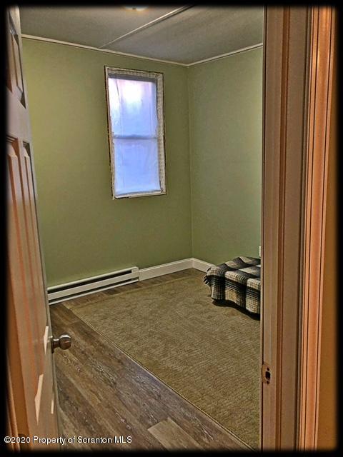 474 Crescent Lake Road Meshoppen, PA 18630 - Photo 18 of 26 a view of a room with wooden floor and windows