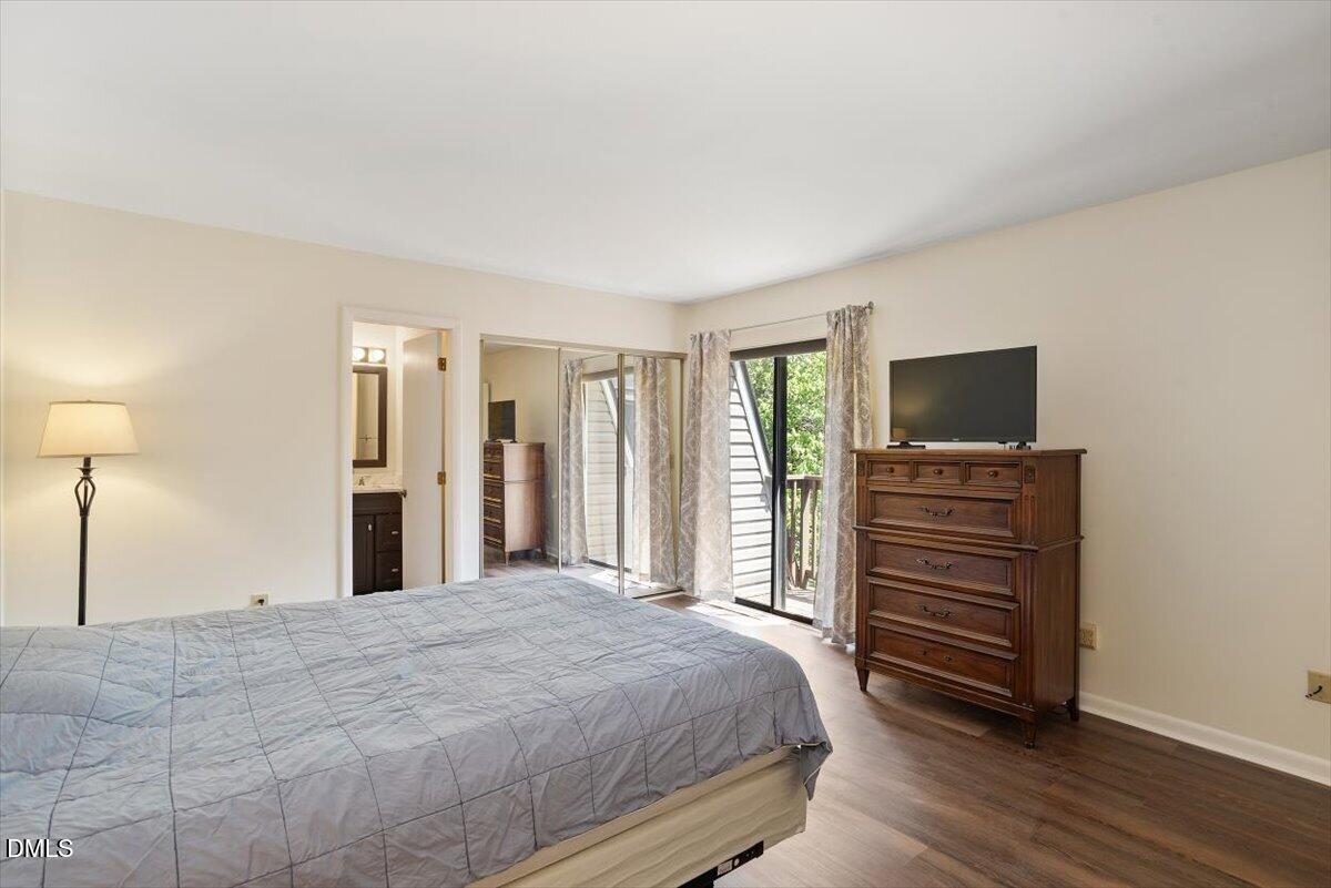 163 Springberry Lane Chapel Hill, NC 27517 - Photo 17 of 32 a bedroom with a bed and a flat screen tv