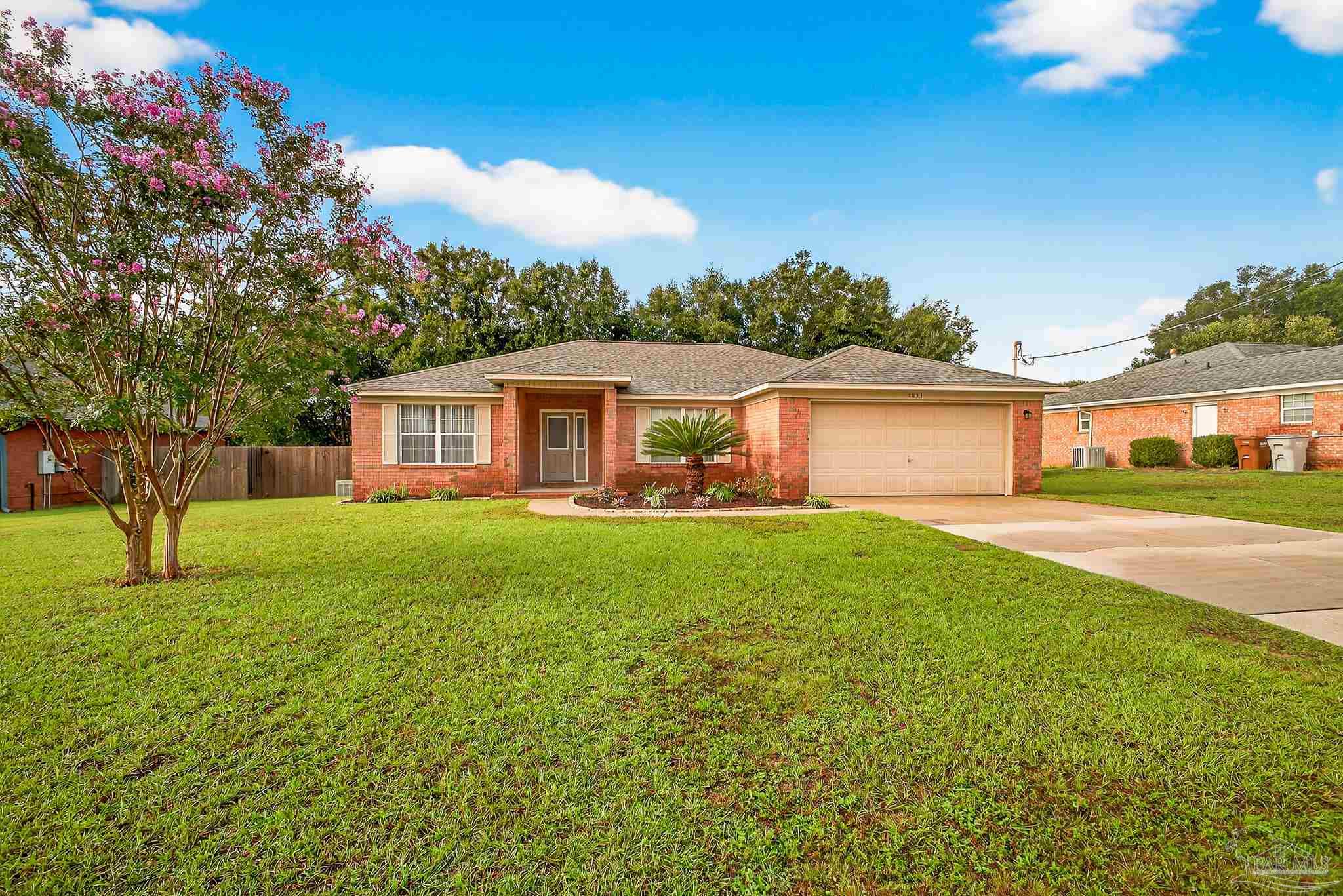 5053 Copperfield Drive Pace, FL 32571 - Photo 1 of 52 a front view of a house with yard and green space