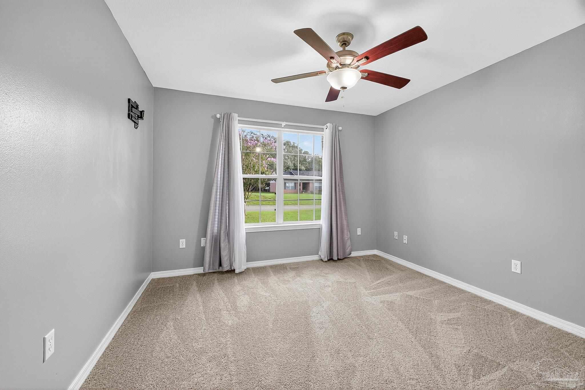 5053 Copperfield Drive Pace, FL 32571 - Photo 11 of 52 an empty room with ceiling fan and windows