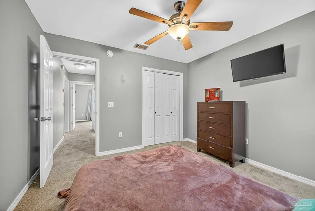 view of a hallway with wooden floor and closet area
