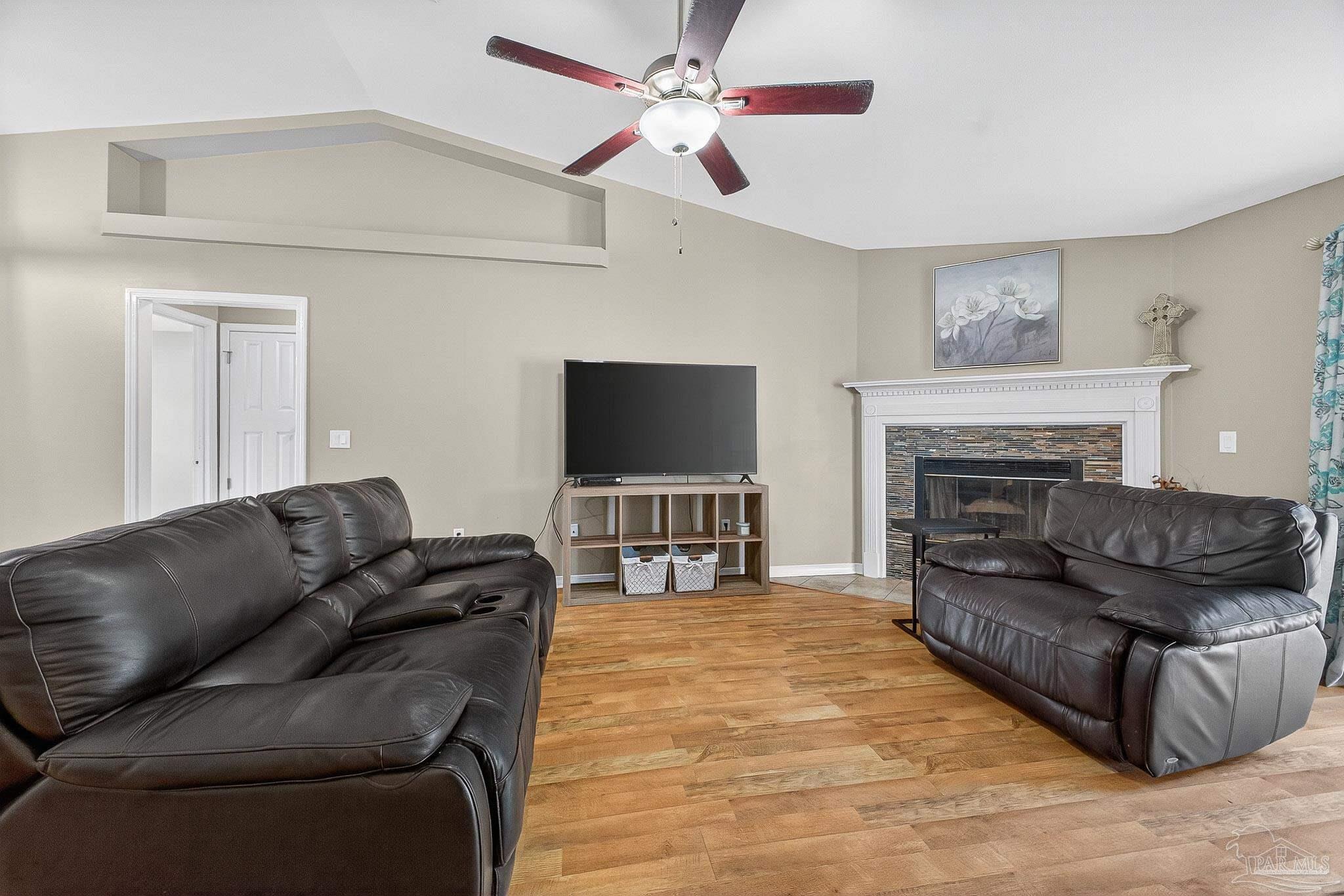 5053 Copperfield Drive Pace, FL 32571 - Photo 22 of 52 a living room with furniture and a flat screen tv