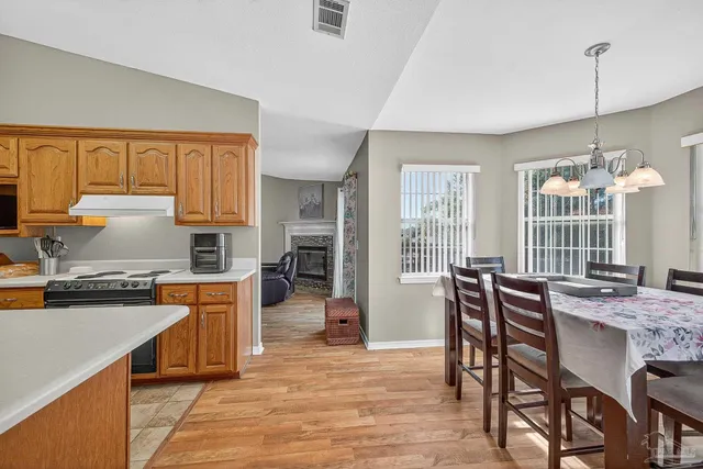 a view of a dining room with furniture and wooden floor