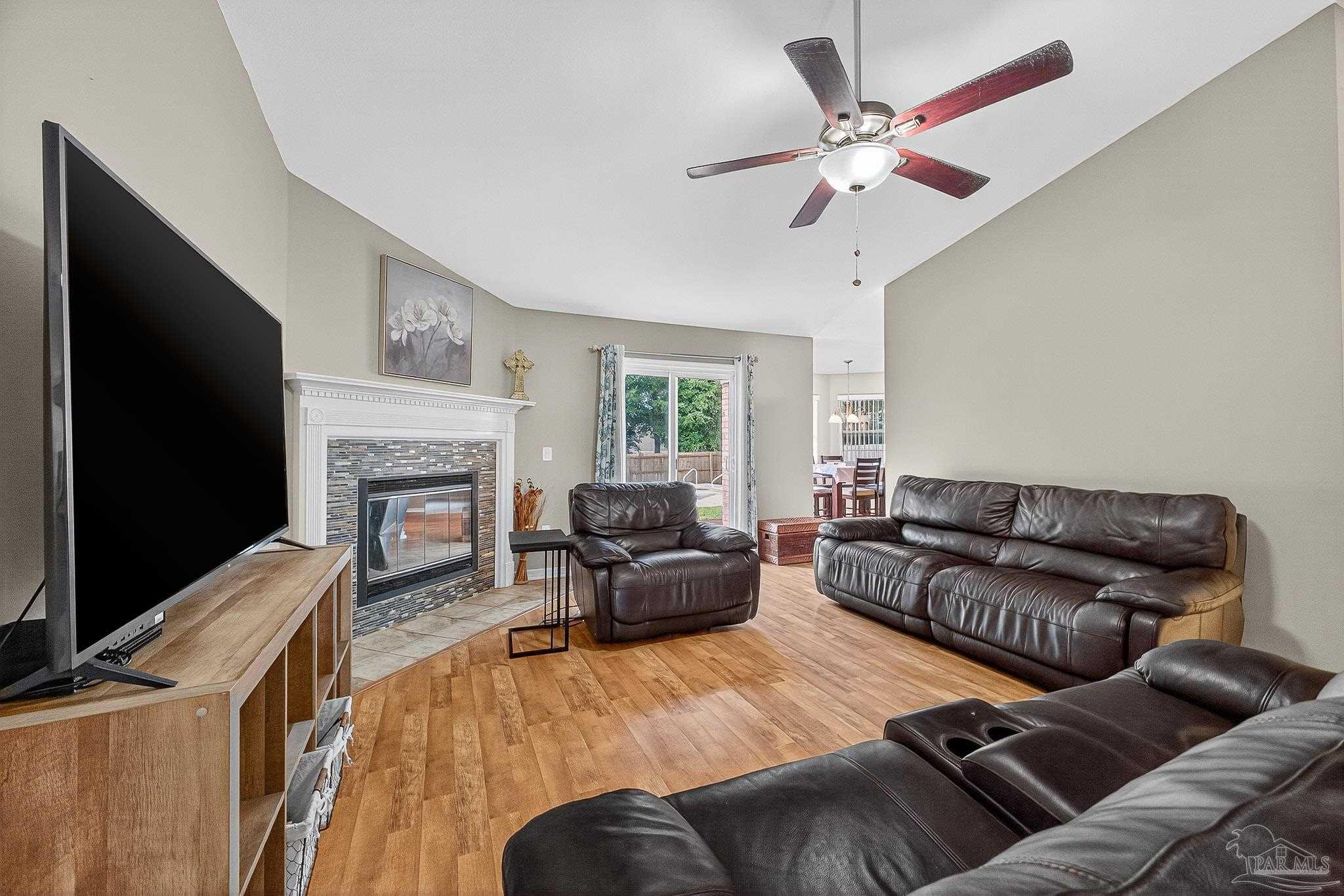 5053 Copperfield Drive Pace, FL 32571 - Photo 3 of 52 a living room with furniture and a fireplace