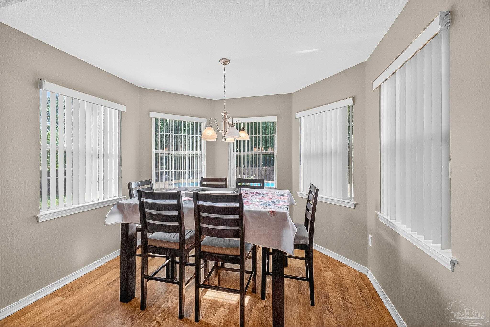 5053 Copperfield Drive Pace, FL 32571 - Photo 31 of 52 a view of a dining room with furniture and wooden floor