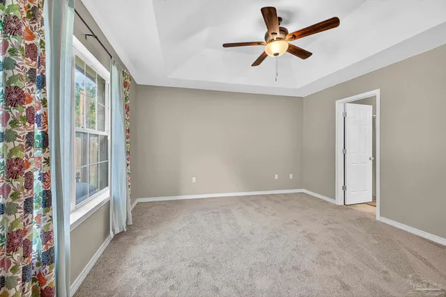 an empty room and chandelier fan