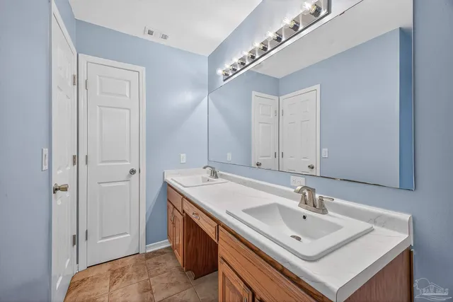 a bathroom with a tub a sink and a shower