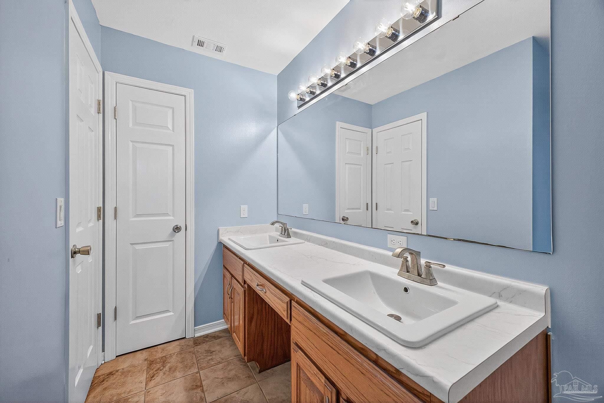5053 Copperfield Drive Pace, FL 32571 - Photo 36 of 52 a bathroom with a sink and a mirror