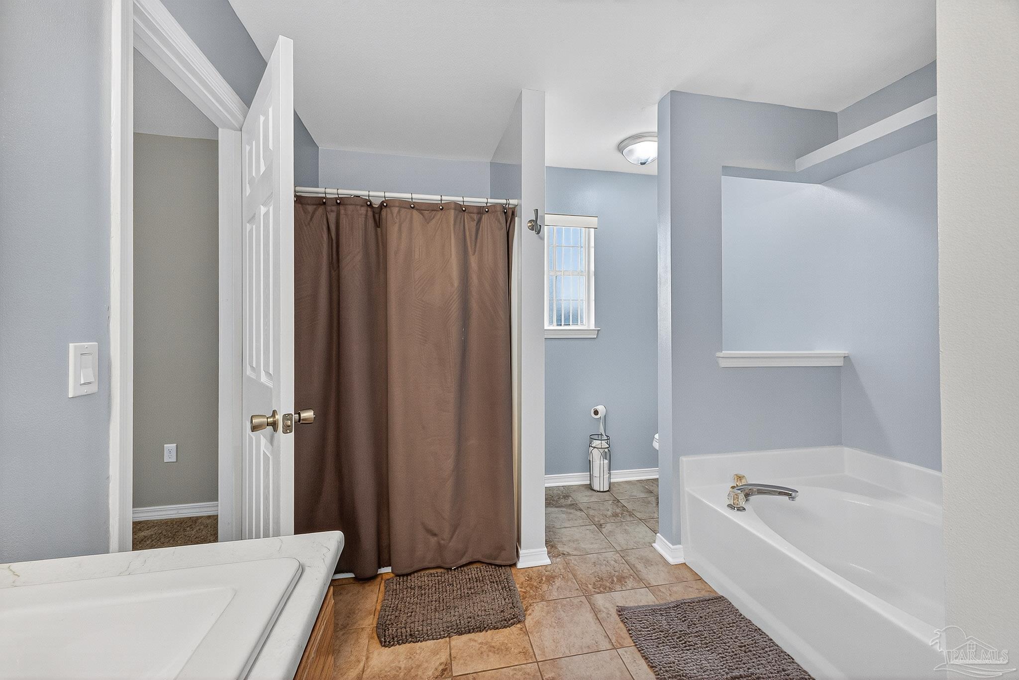 5053 Copperfield Drive Pace, FL 32571 - Photo 37 of 52 a bathroom with a tub a sink and a shower