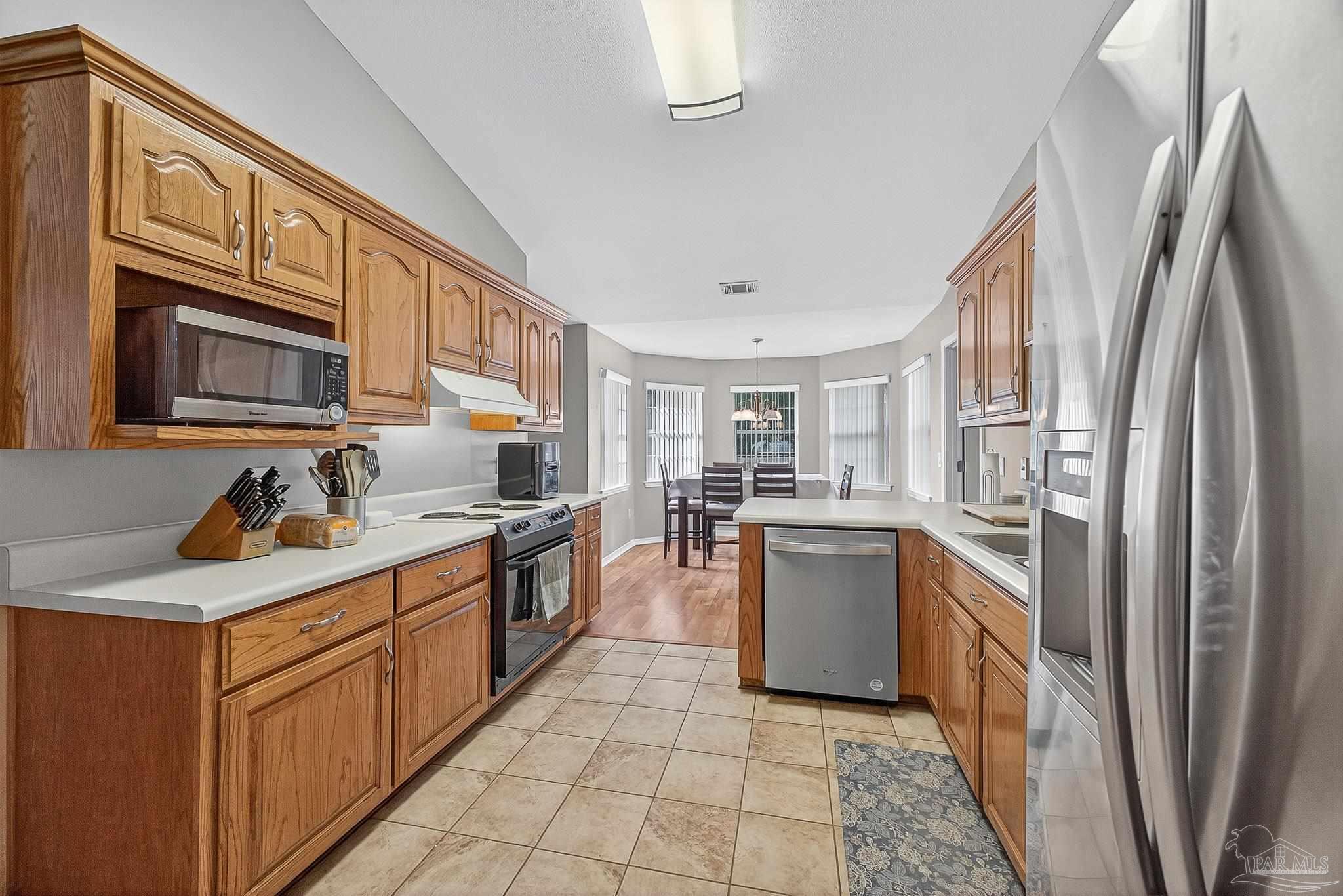 5053 Copperfield Drive Pace, FL 32571 - Photo 4 of 52 a kitchen with a sink stove and refrigerator
