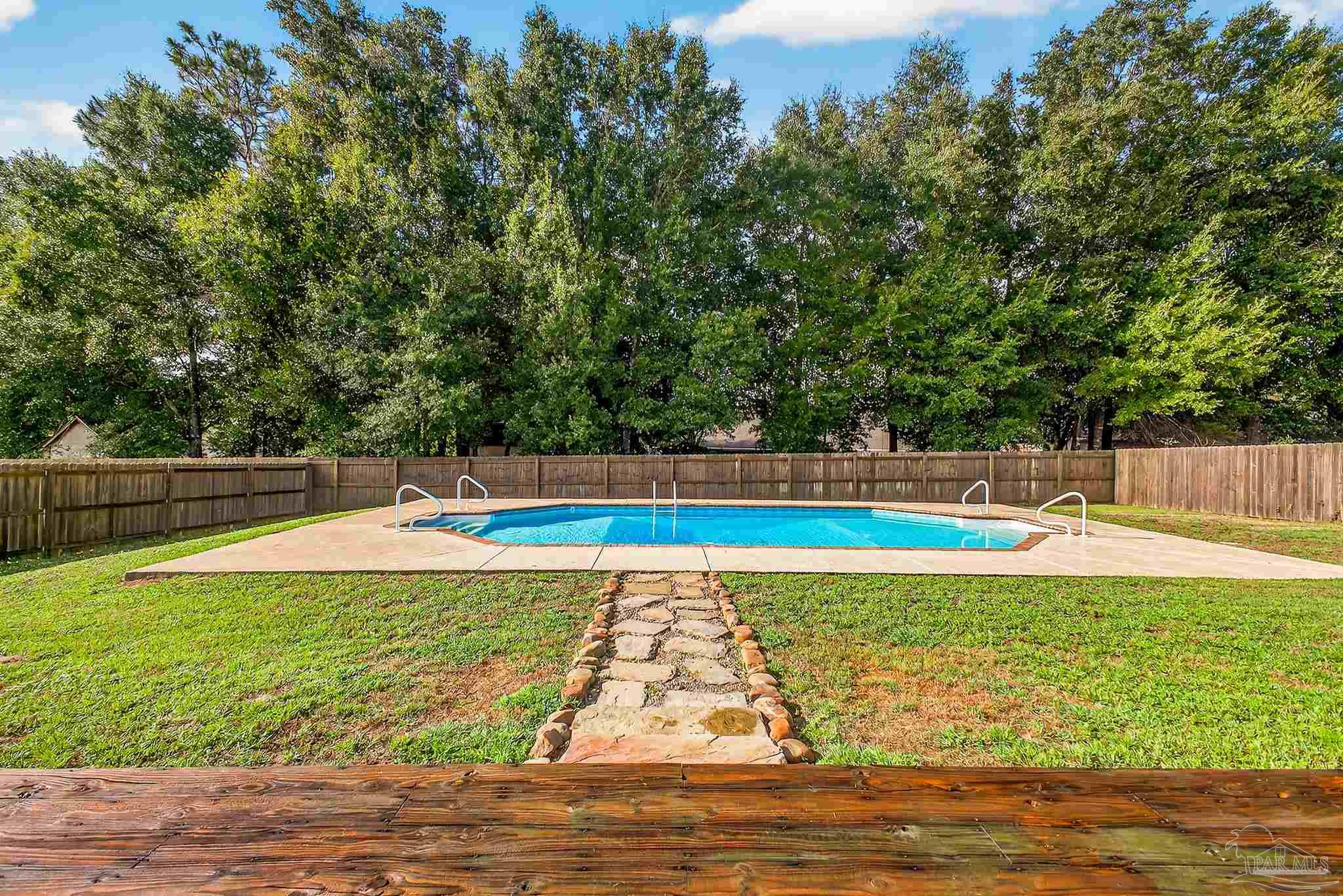 5053 Copperfield Drive Pace, FL 32571 - Photo 44 of 52 a view of a swimming pool with an outdoor space and seating area