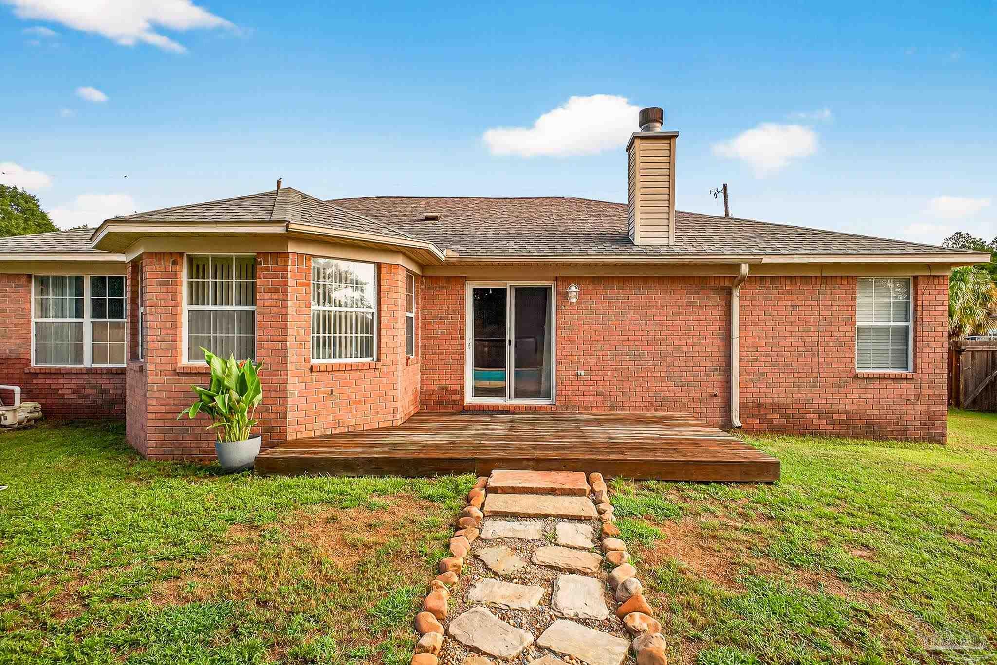 5053 Copperfield Drive Pace, FL 32571 - Photo 49 of 52 a front view of a house with garden