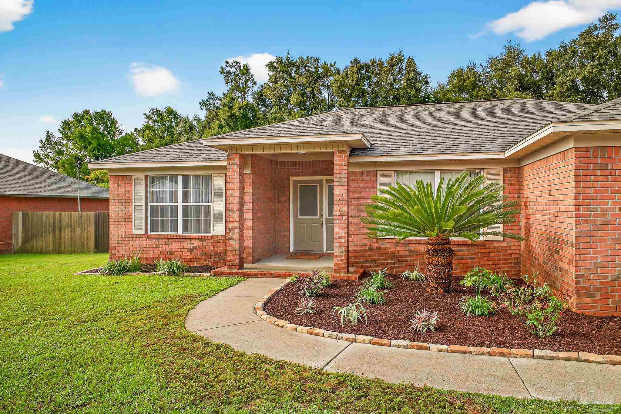 5053 Copperfield Drive Pace, FL 32571 - Photo 7 of 52 a front view of a house with garden