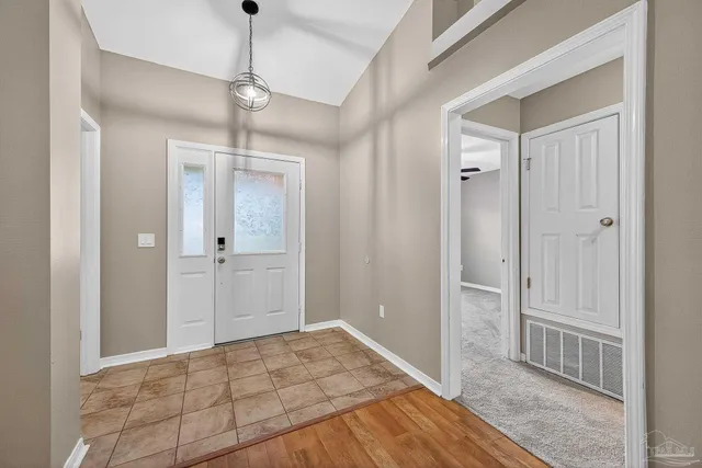 a view of a room with wooden floor and cabinet