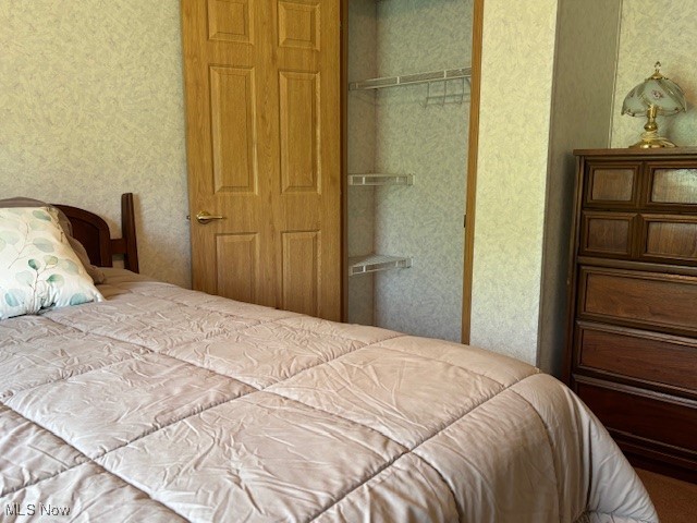 12575 Zane Road Lore City, OH 43755 - Photo 31 of 37 Bedroom with a closet and wallpapered walls