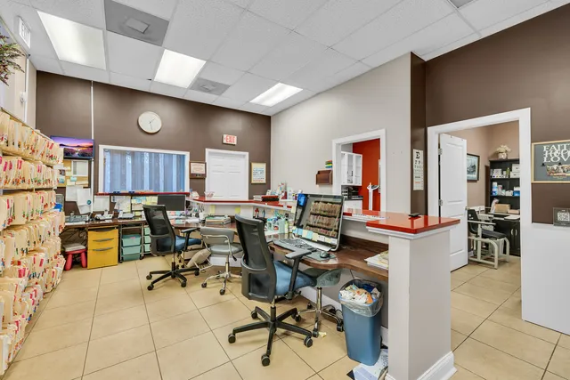 a kitchen with a chair and white cabinets