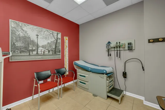 a view of a workspace with furniture and a bookshelf