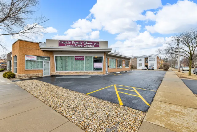 a living room with furniture large window and wooden floor