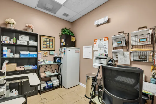 a room with furniture a rug and white walls