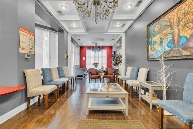 a living room with furniture and a chandelier