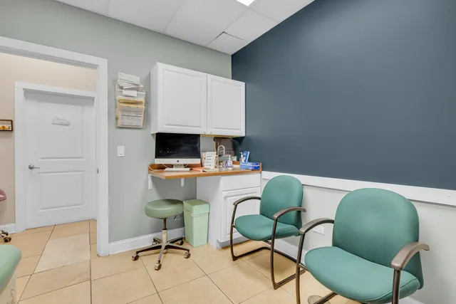 a work room with furniture and a flat screen tv