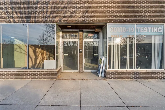 a view of a hallway with furniture and a chandelier