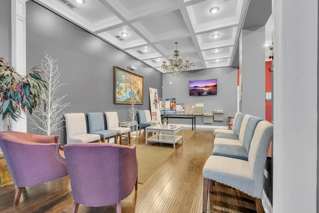 a living room with dining room and wooden floor