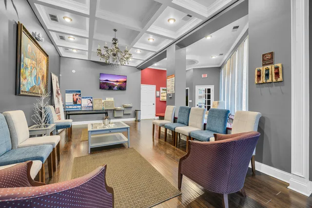 a living room with furniture a chandelier and a flat screen tv