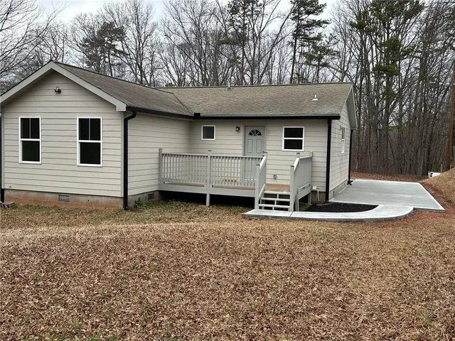 a view of a white house with a yard and garage