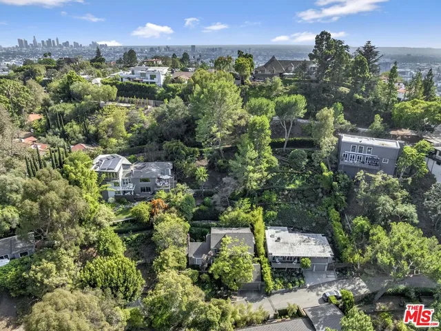 an aerial view of a house with a yard