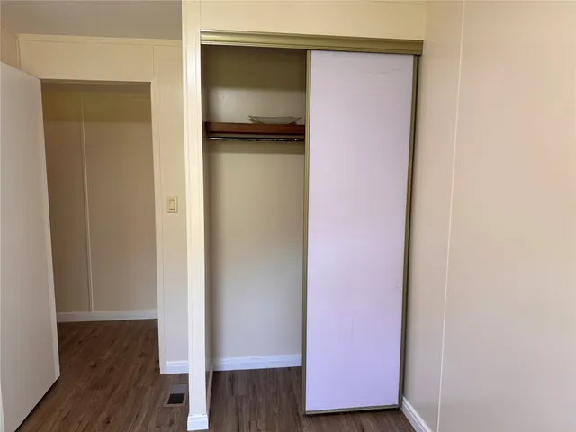 a view of a room with wooden floor