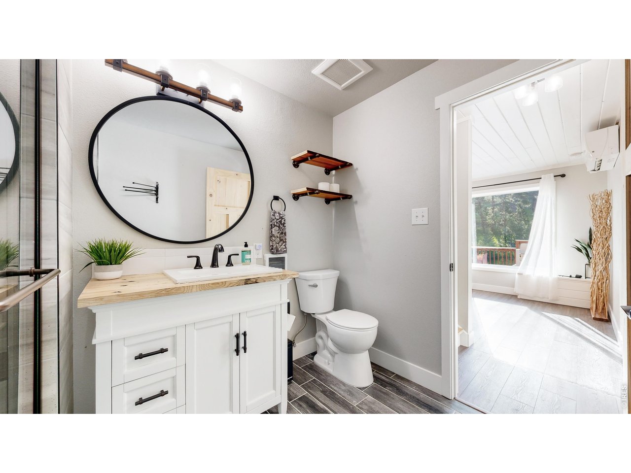 1268 Spring Valley Road Bellvue, CO 80512 - Photo 16 of 33 a bathroom with a sink a toilet and a mirror