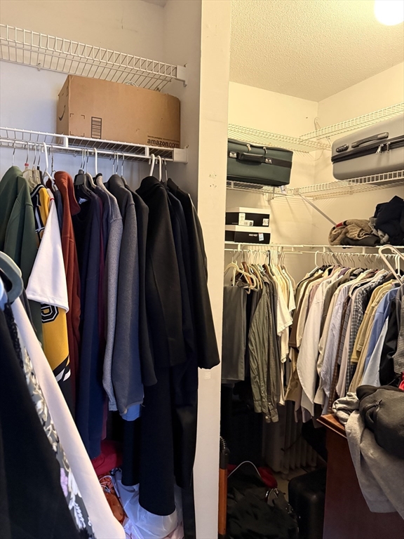 1511 Dunhamtown Brimfield Road Brimfield, MA 01010 - Photo 20 of 36 a view of walk in closet with clothes and shoes