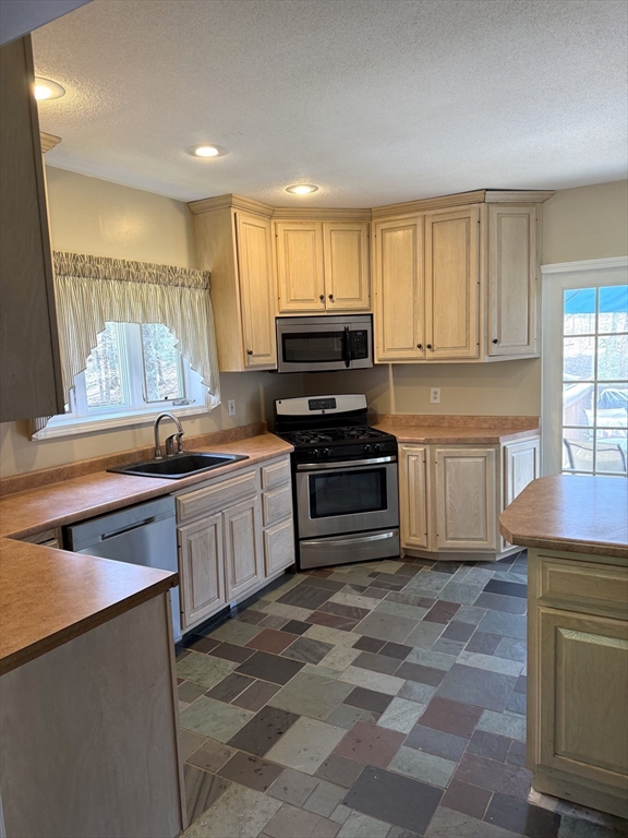 1511 Dunhamtown Brimfield Road Brimfield, MA 01010 - Photo 6 of 36 a kitchen with granite countertop a sink cabinets and stainless steel appliances