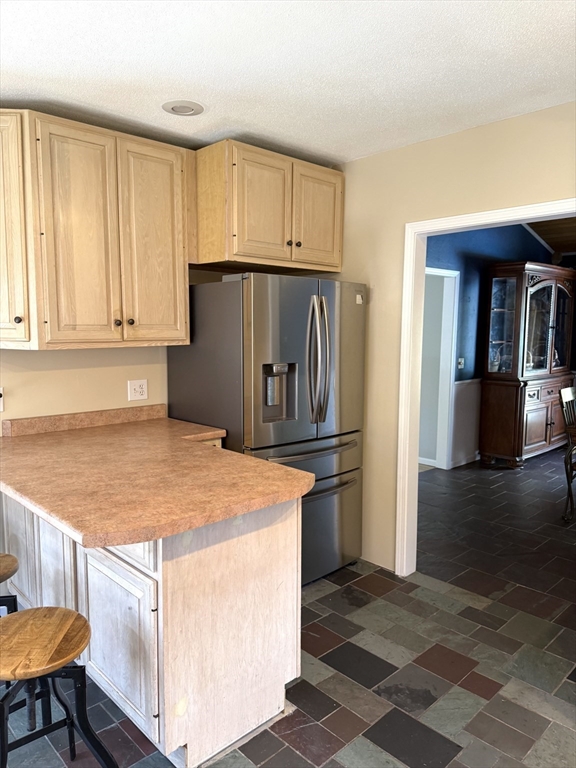 1511 Dunhamtown Brimfield Road Brimfield, MA 01010 - Photo 7 of 36 a kitchen with stainless steel appliances granite countertop a refrigerator and a stove top oven