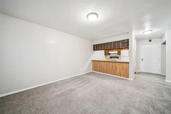 a kitchen with stainless steel appliances granite countertop a sink a stove and white cabinets