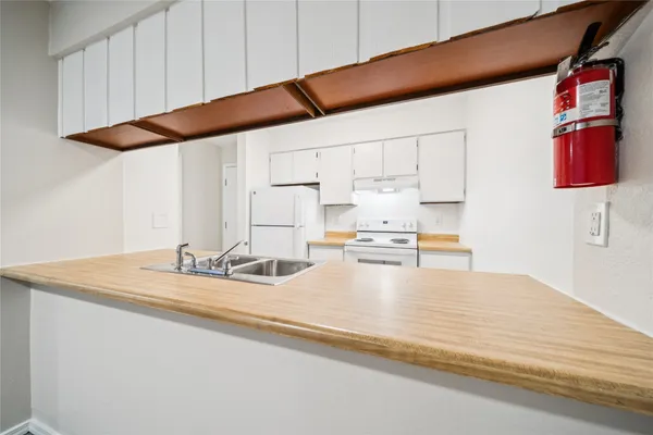 a kitchen with a sink and a refrigerator