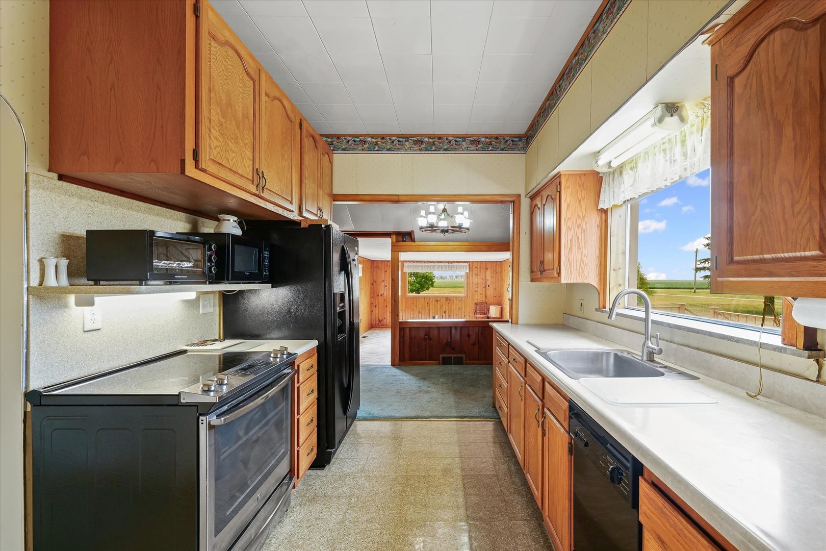 6292 North 100 East Road Allerton, IL 61810 - Photo 16 of 61 a kitchen with stainless steel appliances granite countertop a sink stove and refrigerator