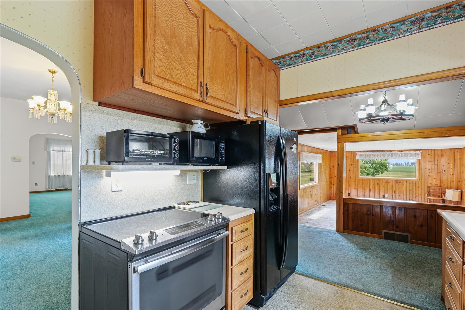 6292 North 100 East Road Allerton, IL 61810 - Photo 17 of 61 a kitchen with stainless steel appliances granite countertop a stove a sink and a refrigerator